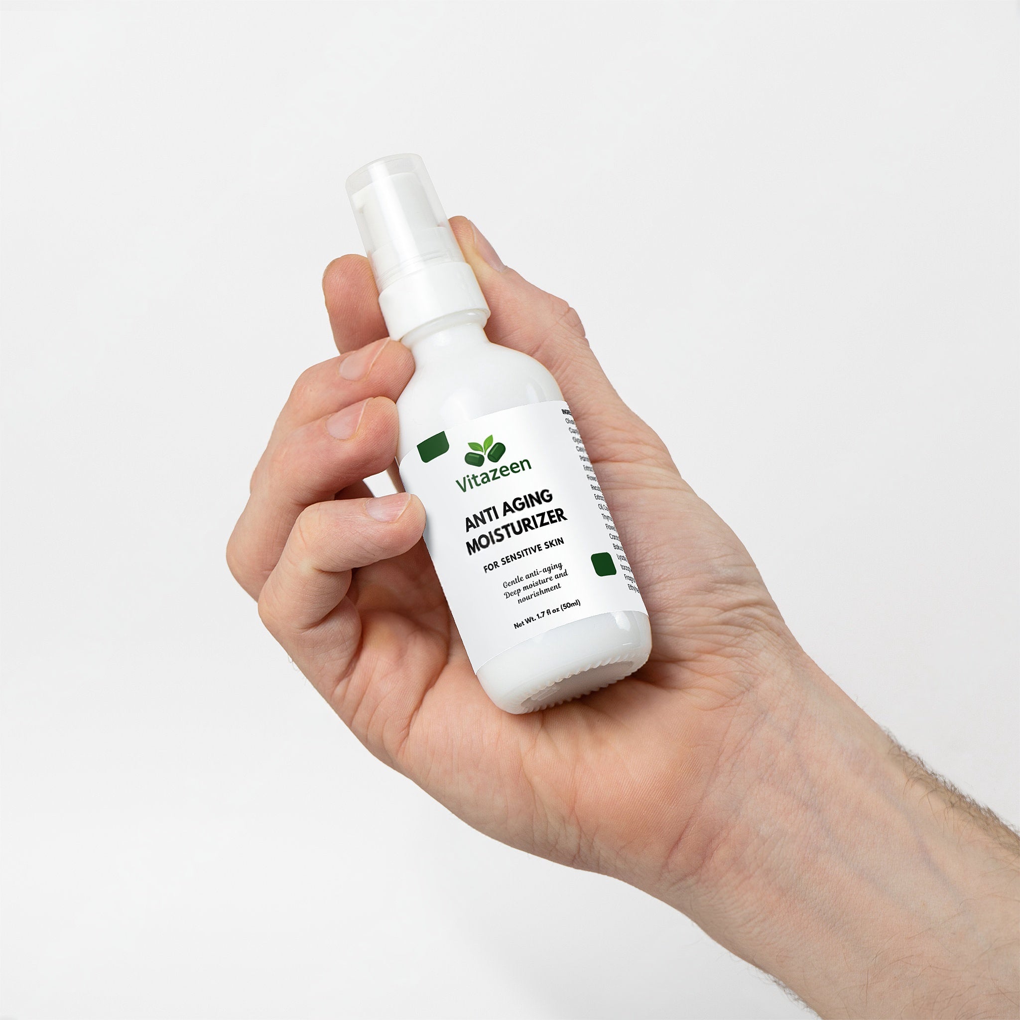 Hand holding a bottle of Vitazen anti-aging moisturizer against a white background