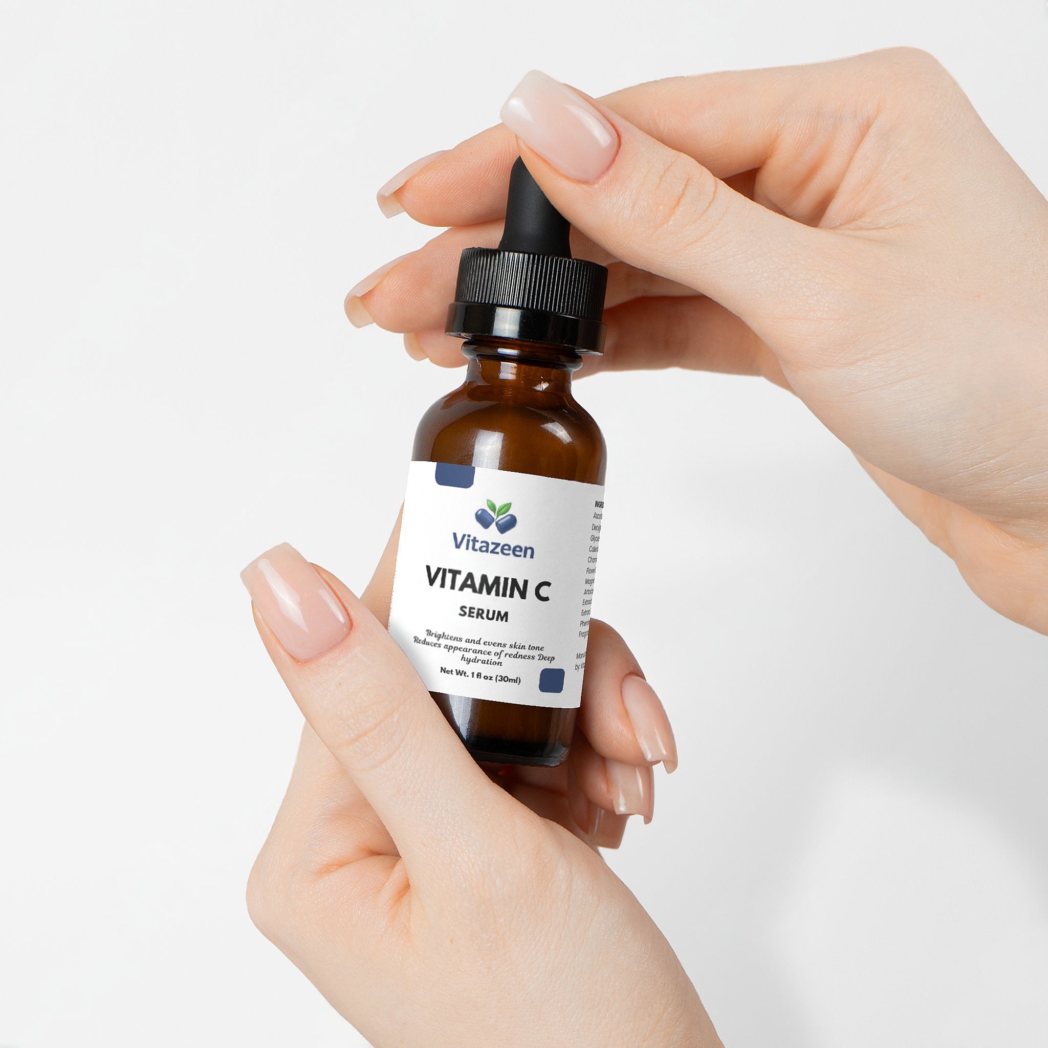 VitaZein Vitamin C serum bottle held by a hand on a white background