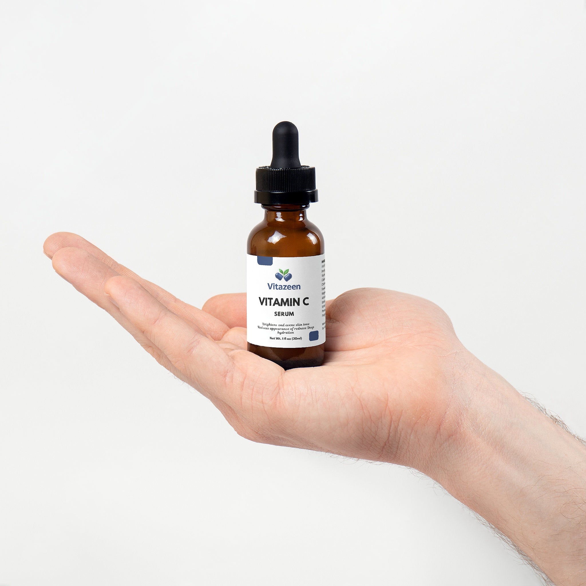 Hand holding a bottle of Vitezen Vitamin C Serum against a white background