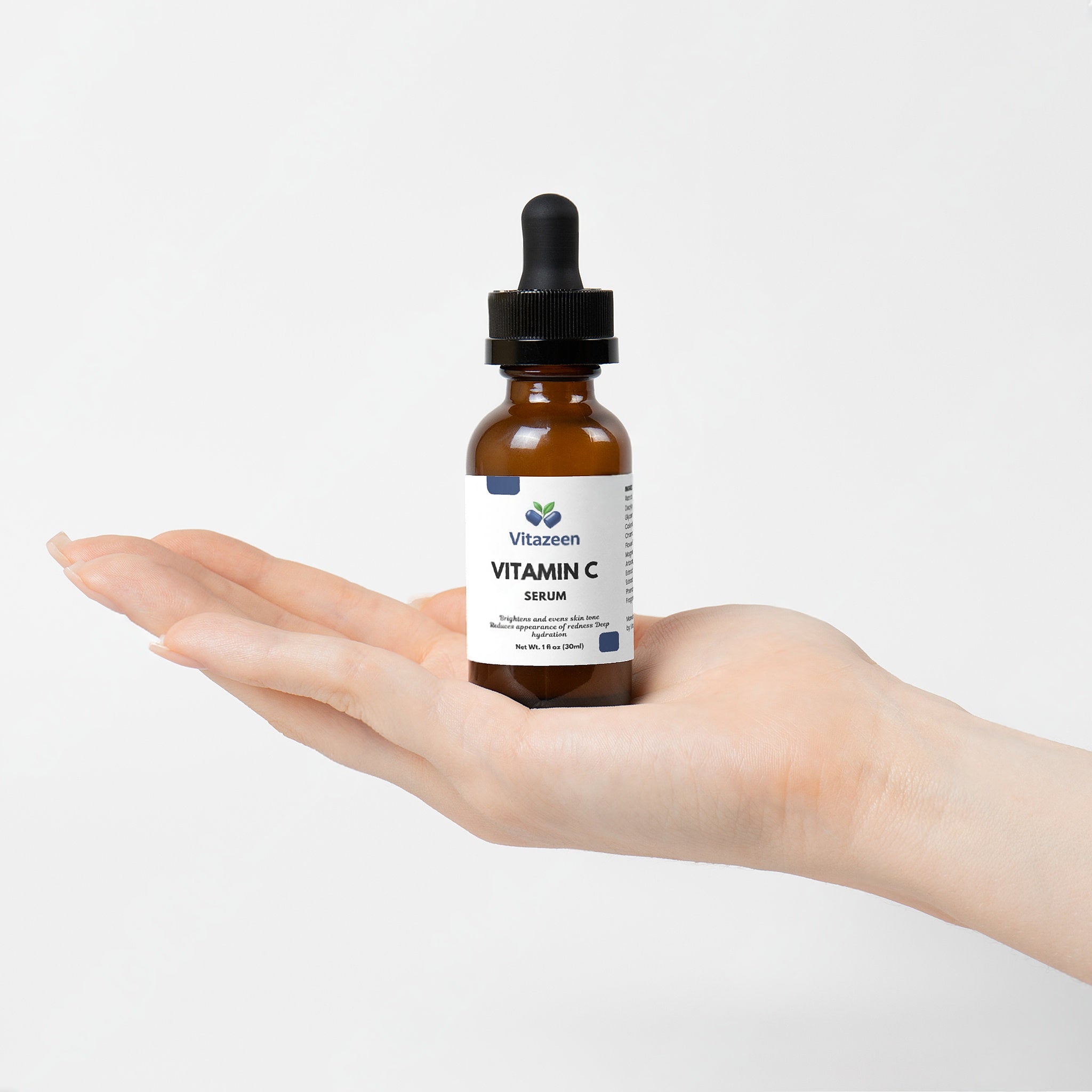 VitaZeem Vitamin C serum bottle held in a hand against a white background