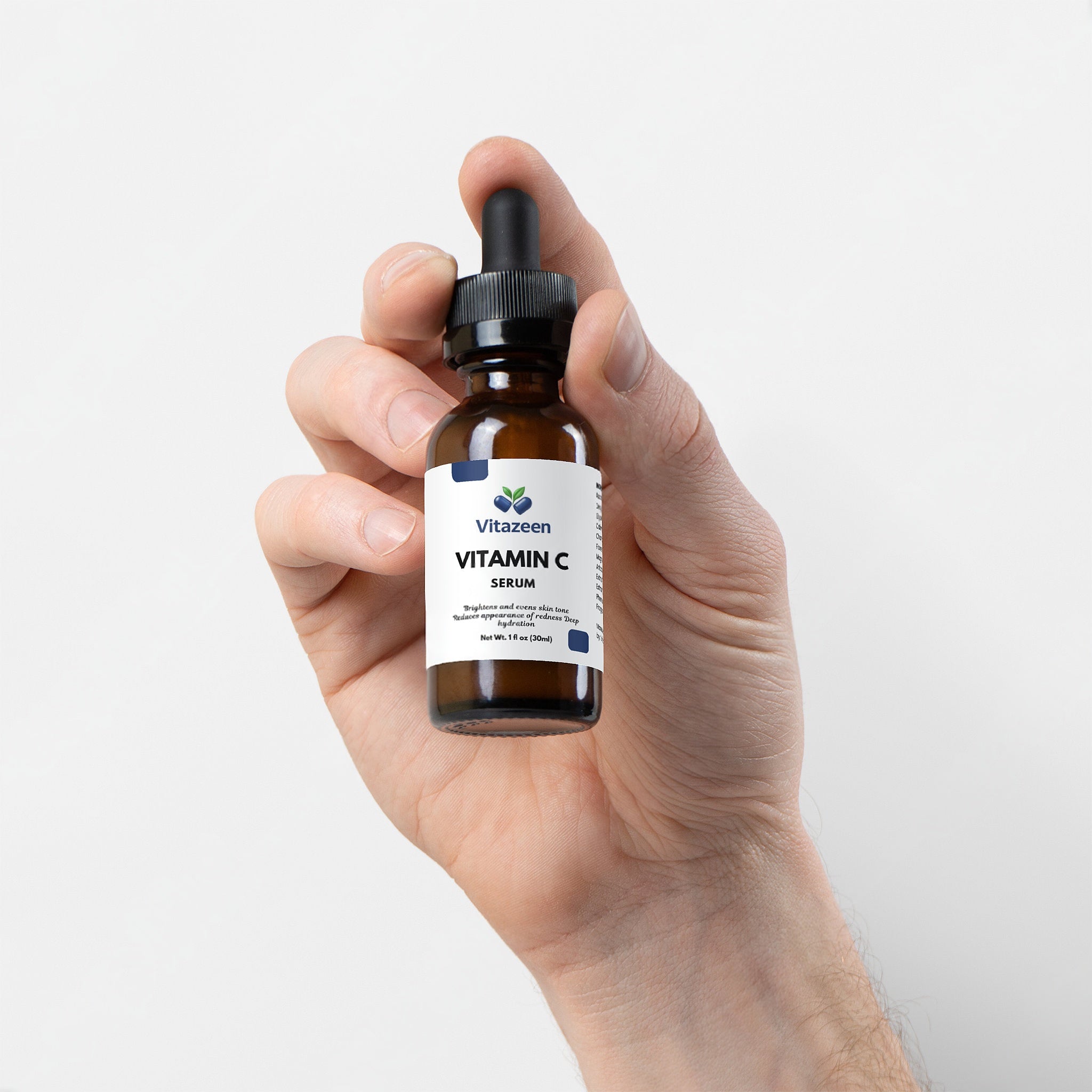 Hand holding a bottle of Vitateen Vitamin C Serum against a white background