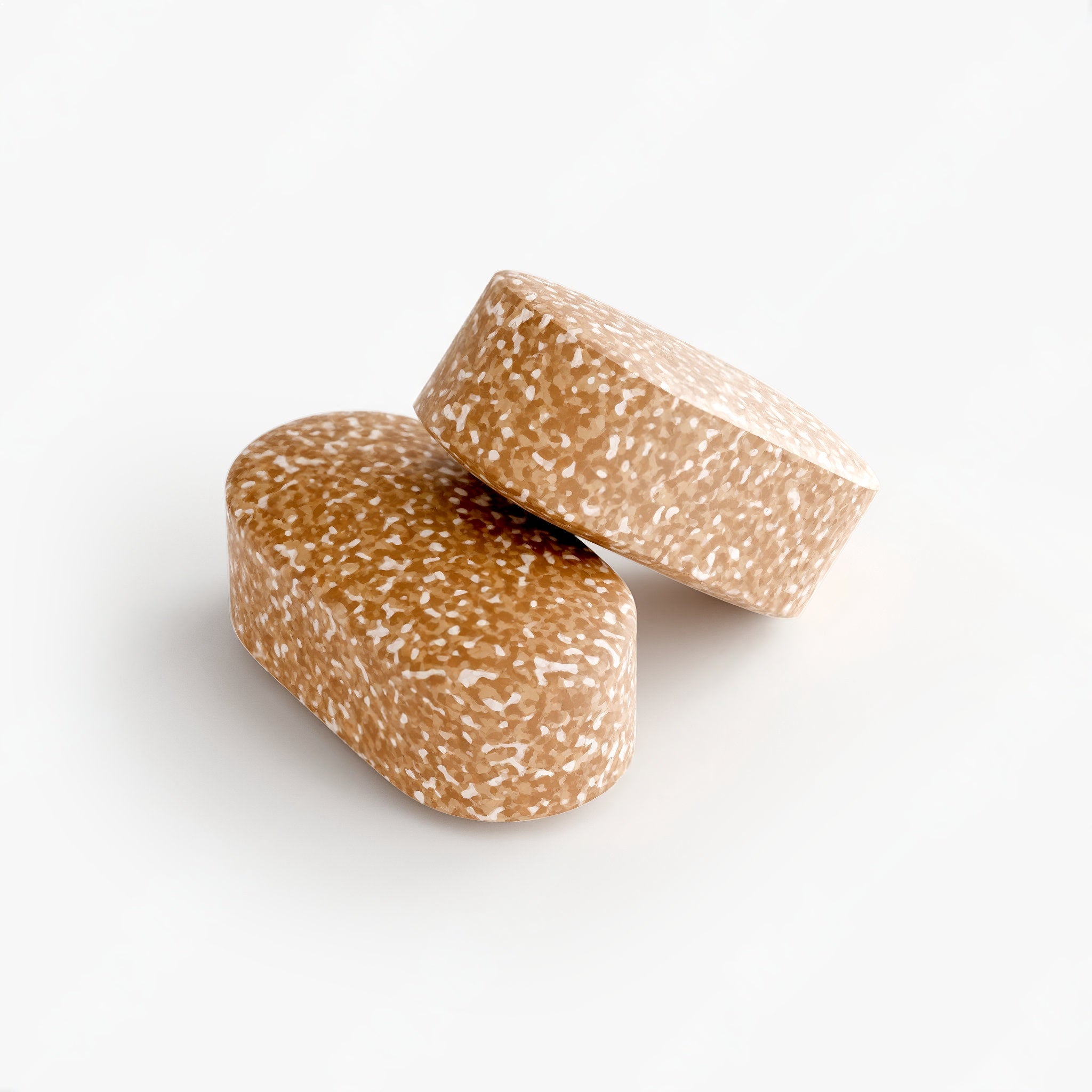 Two brown speckled stones on a white background